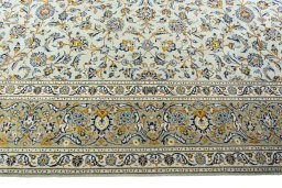Corner detail of 2000s Kashan rug showing border pattern and Wool pile