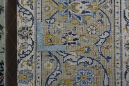 Backside of handmade 2000s Kashan rug showing knot structure and weave density