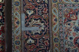 Backside of handmade New Kashan rug showing knot structure and weave density