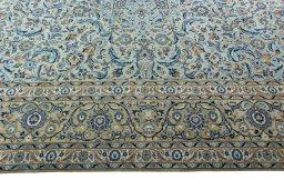 Corner detail of 2000s Kashan rug showing border pattern and Wool pile