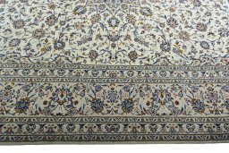 Corner detail of 2000s Kashan rug showing border pattern and Wool pile