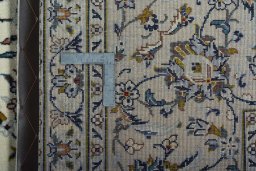 Backside of handmade 2000s Kashan rug showing knot structure and weave density