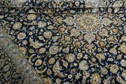 Close-up detail of 2000s Kashan rug from Iran / Persia showing Wool weave