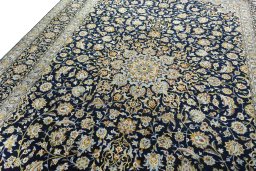 Backside of handmade 2000s Kashan rug showing knot structure and weave density