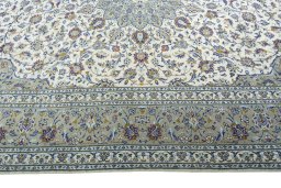 Corner detail of 2000s Kashan rug showing border pattern and Wool pile