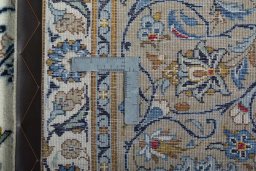 Backside of handmade 2000s Kashan rug showing knot structure and weave density