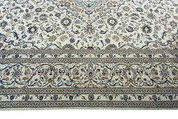 Corner detail of 2000s Kashan rug showing border pattern and Wool pile