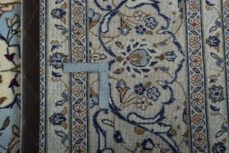 Backside of handmade 2000s Kashan rug showing knot structure and weave density