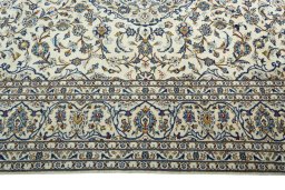 Corner detail of 2000s Kashan rug showing border pattern and Wool pile