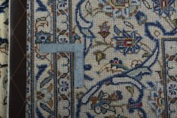 Backside of handmade 2000s Kashan rug showing knot structure and weave density