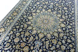 Backside of handmade 2000s Kashan rug showing knot structure and weave density