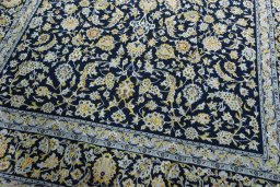 Close-up detail of 2000s Kashan rug from Iran / Persia showing Wool weave