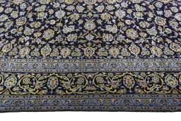Corner detail of 2000s Kashan rug showing border pattern and Wool pile