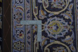 Backside of handmade 2000s Kashan rug showing knot structure and weave density