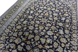 Backside of handmade 2000s Kashan rug showing knot structure and weave density