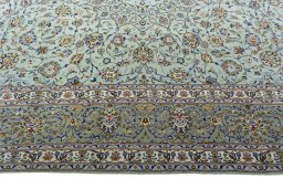 Corner detail of 2000s Kashan rug showing border pattern and Wool pile