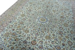 Backside of handmade 2000s Kashan rug showing knot structure and weave density