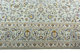 Corner detail of 2000s Kashan rug showing border pattern and Wool pile