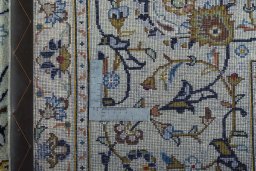 Backside of handmade 2000s Kashan rug showing knot structure and weave density