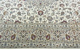Corner detail of 2000s Kashan rug showing border pattern and Wool pile