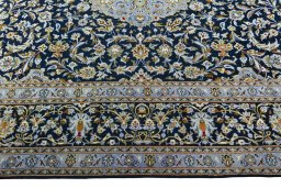 Corner detail of 2000s Kashan rug showing border pattern and Wool pile