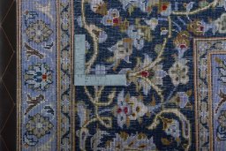 Backside of handmade 2000s Kashan rug showing knot structure and weave density