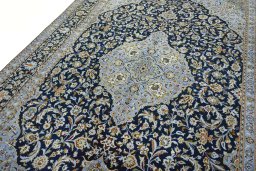 Backside of handmade 2000s Kashan rug showing knot structure and weave density