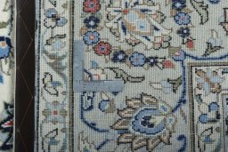 Backside of handmade New Kashan rug showing knot structure and weave density