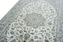Backside of handmade New Kashan rug showing knot structure and weave density