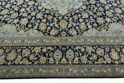 Corner detail of 2000s Kashan rug showing border pattern and Wool pile