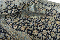 Surface texture of 2000s Kashan rug with natural Wool and intricate pattern