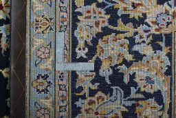 Backside of handmade 2000s Kashan rug showing knot structure and weave density