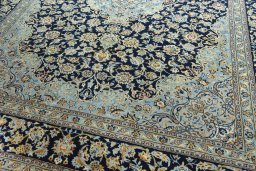 Close-up detail of 2000s Kashan rug from Iran / Persia showing Wool weave