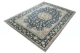 Corner detail of 2000s Kashan rug showing border pattern and Wool pile