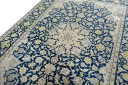 Backside of handmade 2000s Kashan rug showing knot structure and weave density