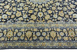 Corner detail of 2000s Kashan rug showing border pattern and Wool pile