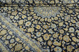 Close-up detail of 2000s Kashan rug from Iran / Persia showing Wool weave