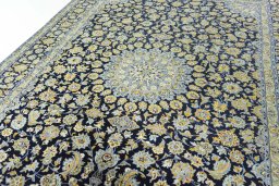 Backside of handmade 2000s Kashan rug showing knot structure and weave density