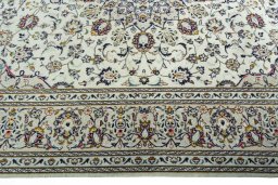 Corner detail of 2000s Kashan rug showing border pattern and Wool pile