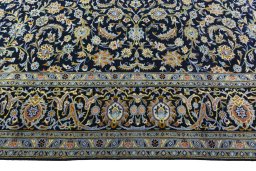 Corner detail of 2000s Kashan rug showing border pattern and Wool pile