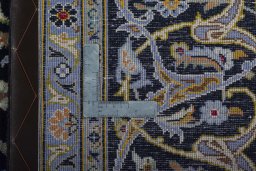 Backside of handmade 2000s Kashan rug showing knot structure and weave density