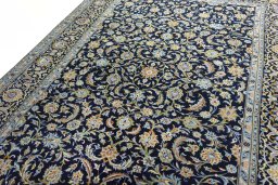 Backside of handmade 2000s Kashan rug showing knot structure and weave density