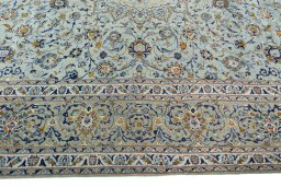 Corner detail of 2000s Kashan rug showing border pattern and Wool pile