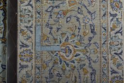 Backside of handmade 2000s Kashan rug showing knot structure and weave density