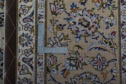 Backside of handmade 2000s Kashan rug showing knot structure and weave density