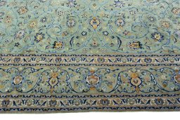 Corner detail of 2000s Kashan rug showing border pattern and Wool pile