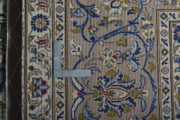 Backside of handmade 2000s Kashan rug showing knot structure and weave density