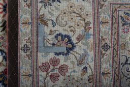 Backside of handmade New Kashan rug showing knot structure and weave density