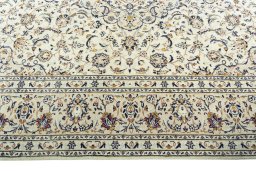 Corner detail of 2000s Kashan rug showing border pattern and Wool pile