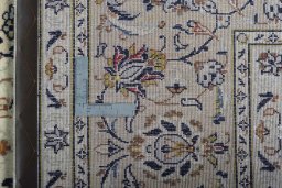 Backside of handmade 2000s Kashan rug showing knot structure and weave density